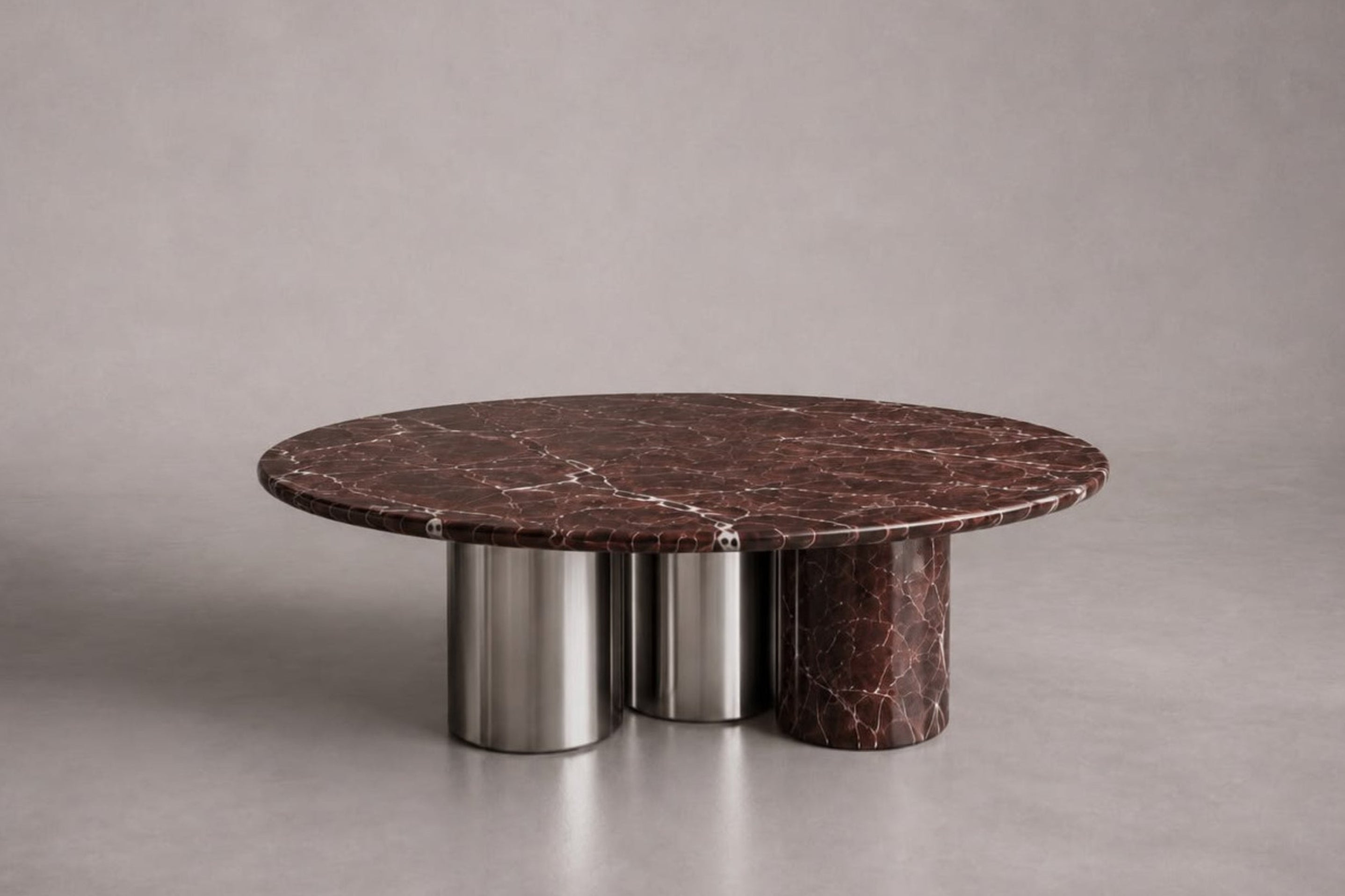 rosso levanto marble coffee table. round marble coffee table. luxury marble coffee table. designer coffee table. mixed material coffee table. sculptural coffee table. custom marble coffee table. Rosso Levanto marble round coffee table with sculptural mixed-material cylindrical legs. Luxury round coffee table in Rosso Levanto marble with sculptural base. Rosso Levanto marble coffee table for luxury interior design projects. Designer Round Marble Coffee Table in Rosso Levanto. 