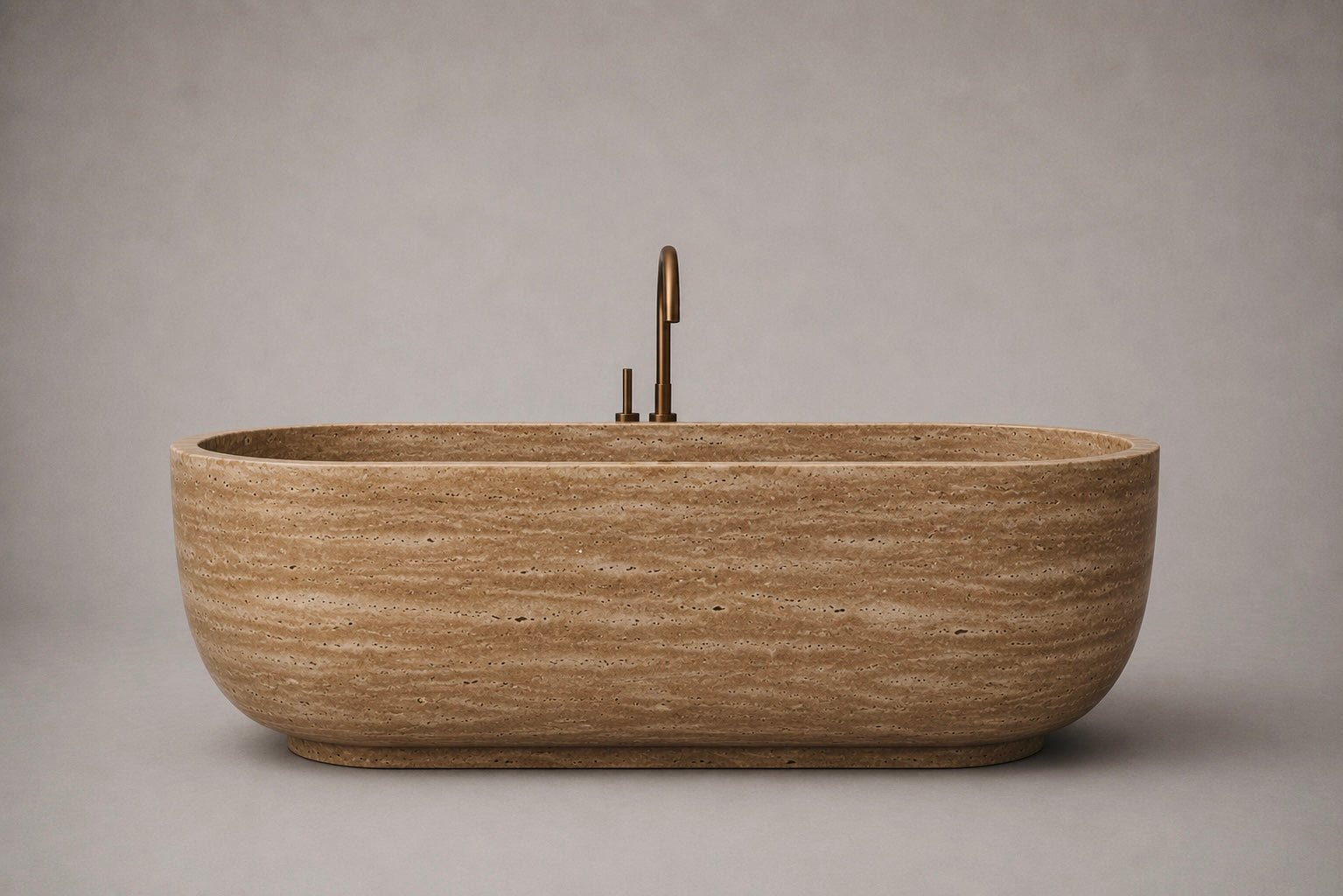 freestanding noche travertine bathtub in honed natural stone with sculptural oval silhouette. Freestanding noche travertine bathtub in warm beige natural stone. Custom noche travertine bathtub handcrafted from natural stone. Luxury natural stone bathtub with minimalist oval form. Handcrafted noche travertine bathtub for luxury bathroom design. Bespoke freestanding noche travertine bathtub for interior design projects. Custom luxury noche travertine bathtub for high end interior.
