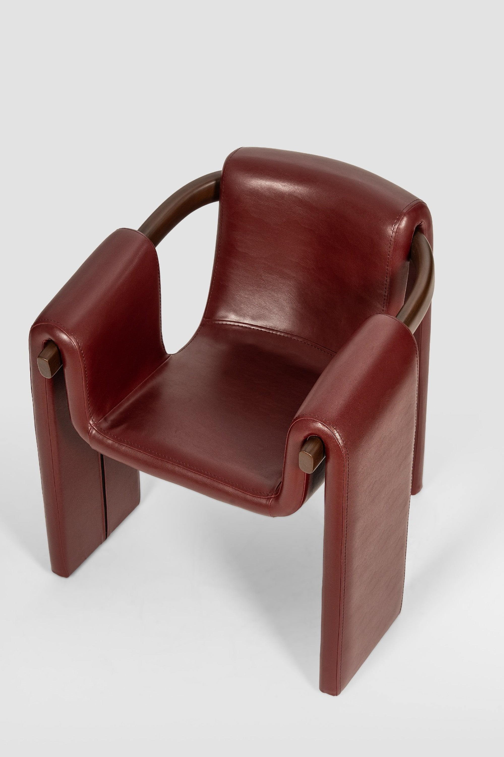 luxury leather dining chair. custom leather dining chair. modern leather dining chair. sculptural dining chair. designer dining chair. high end dining chair. contemporary leather armchair. bespoke dining chair. premium leather seating. architectural dining chair. burgundy leather dining chair. custom luxury leather dining chair USA. made to order leather dining chairs. modern sculptural leather arm dining chair. high end custom seating for interior designers. luxury restaurant leather dining chairs.